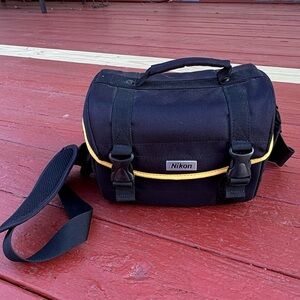 Nikon black camera and accessory shoulder carrying bag